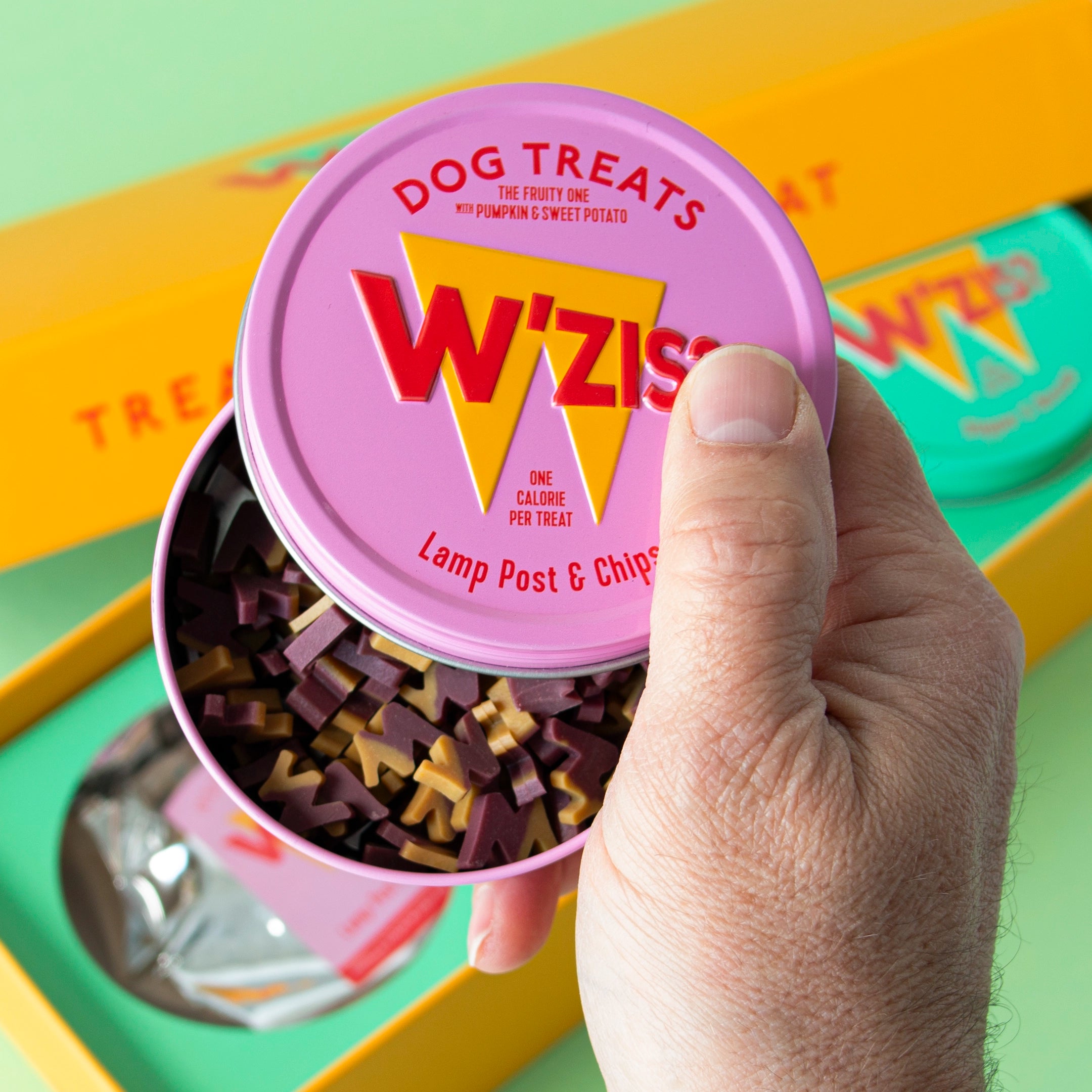 Close-up of W'ZIS Triple Tin Gift Box with Postman & Roast, Slipper & Biscuit, and Lamp Post & Chips
